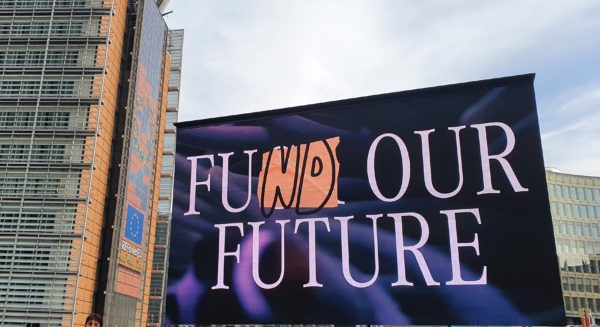 Big screen in front of the European Commission with the words 'fund our future' displayed